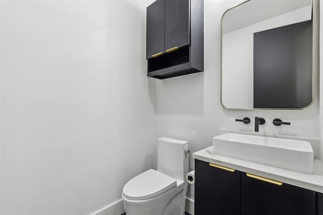 bathroom with toilet and vanity