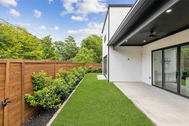 view of yard featuring a patio area and ceiling fan