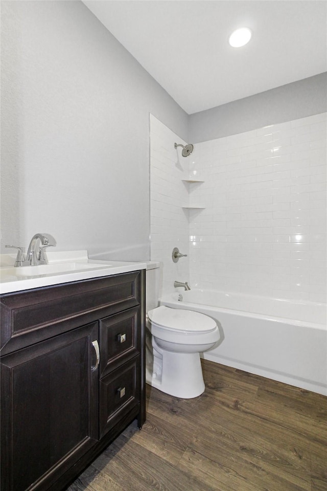 14590 Coffee Ln, Scurry, TX 75158 - bathroom featuring vanity, toilet, wood finished floors,  shower combination, and recessed lighting