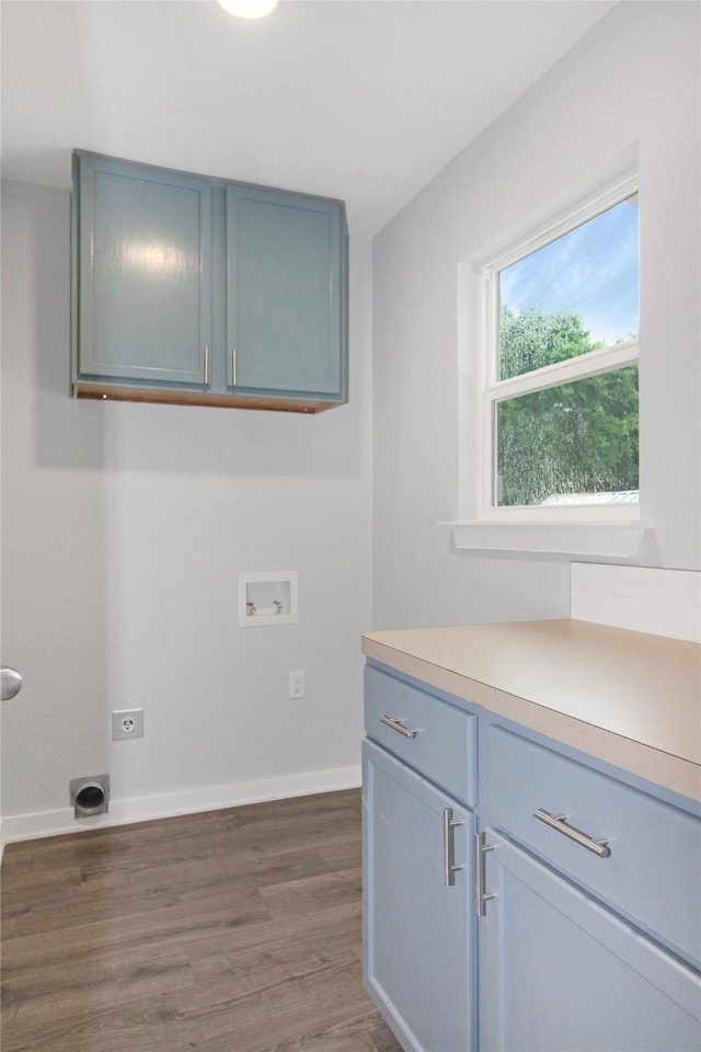 14590 Coffee Ln, Scurry, TX 75158 - laundry room with cabinet space, hookup for a washing machine, hookup for an electric dryer, dark wood-type flooring, and baseboards
