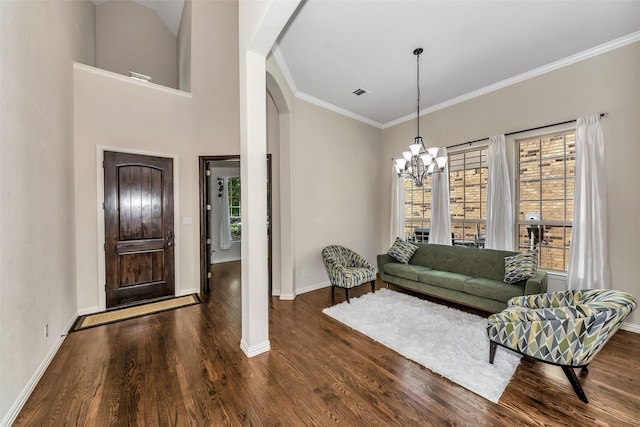 5112 Fringetree Dr, Mckinney, TX 75071 - living room with arched walkways, wood finished floors, baseboards, crown molding, and a chandelier