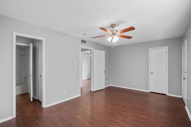 6708 S Creek Dr, Fort Worth, TX 76133 - unfurnished bedroom with wood finished floors, a textured ceiling, baseboards, connected bathroom, and a ceiling fan
