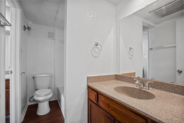 6708 S Creek Dr, Fort Worth, TX 76133 - full bath featuring toilet, a textured wall, wood finished floors, and vanity