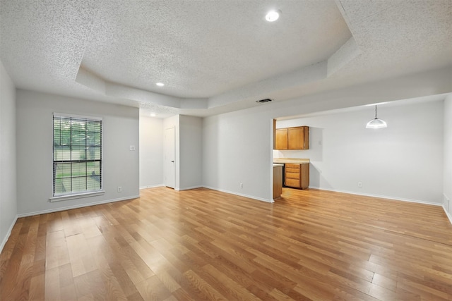 6708 S Creek Dr, Fort Worth, TX 76133 - unfurnished living room with a textured ceiling, light wood-style flooring, a tray ceiling, baseboards, and recessed lighting