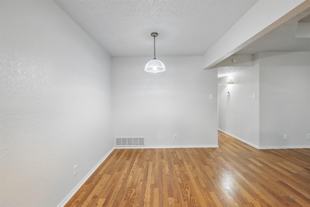 6708 S Creek Dr, Fort Worth, TX 76133 - unfurnished room with baseboards, wood finished floors, and a textured ceiling
