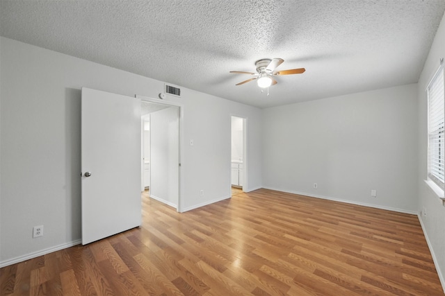 6708 S Creek Dr, Fort Worth, TX 76133 - spare room with a ceiling fan, light wood-style floors, a textured ceiling, and baseboards