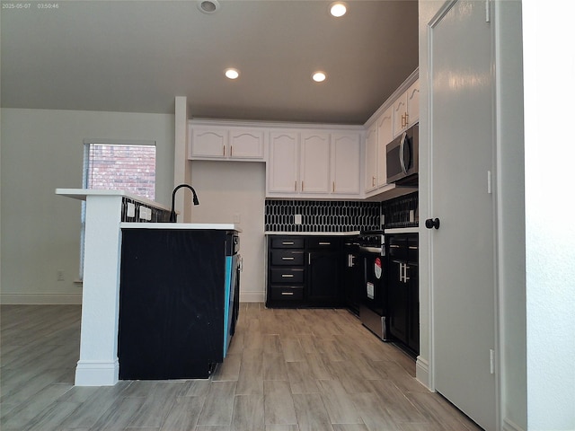 6025 Melanie Dr, Fort Worth, TX 76131 - kitchen with stainless steel microwave, stove, white cabinets, light wood finished floors, and recessed lighting