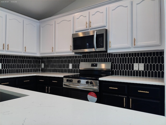 6025 Melanie Dr, Fort Worth, TX 76131 - kitchen featuring stainless steel appliances, white cabinetry, tasteful backsplash, and vaulted ceiling