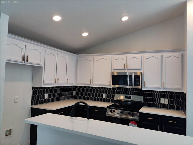 6025 Melanie Dr, Fort Worth, TX 76131 - kitchen featuring stainless steel appliances, white cabinetry, vaulted ceiling, light countertops, and decorative backsplash