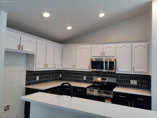 6025 Melanie Dr, Fort Worth, TX 76131 - kitchen featuring stainless steel appliances, white cabinetry, vaulted ceiling, light countertops, and decorative backsplash