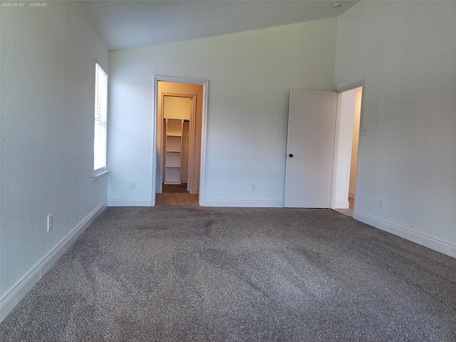 6025 Melanie Dr, Fort Worth, TX 76131 - unfurnished bedroom with lofted ceiling, carpet floors, a walk in closet, and baseboards