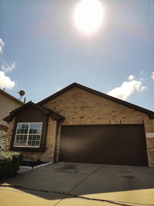 6025 Melanie Dr, Fort Worth, TX 76131 - ranch-style home with an attached garage, concrete driveway, and brick siding