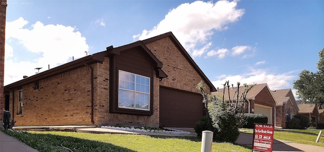 6025 Melanie Dr, Fort Worth, TX 76131 - view of side of home featuring a garage, brick siding, and a yard