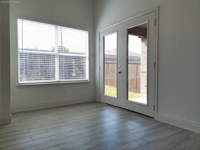 6025 Melanie Dr, Fort Worth, TX 76131 - unfurnished room featuring plenty of natural light, wood finished floors, french doors, and baseboards
