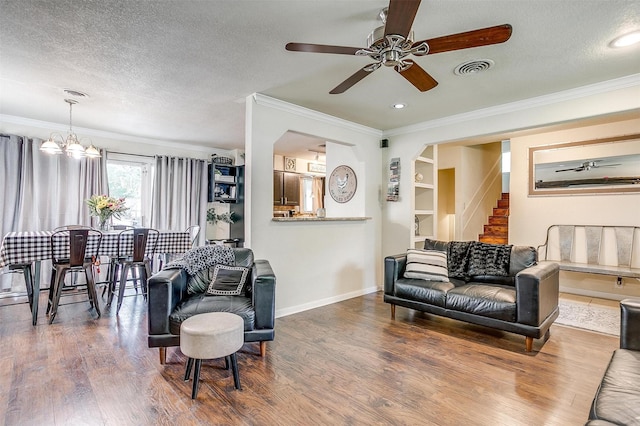 3554 Cromart Ct N, Fort Worth, TX 76133 - living room with wood finished floors, a chandelier, ornamental molding, stairway, and a ceiling fan