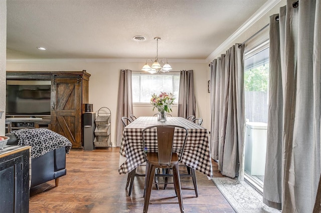 3554 Cromart Ct N, Fort Worth, TX 76133 - dining area featuring healthy amount of natural light, a chandelier, ornamental molding, and wood finished floors