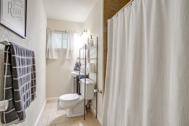 3554 Cromart Ct N, Fort Worth, TX 76133 - full bathroom featuring tile patterned flooring, a textured wall, toilet, a shower with curtain, and baseboards