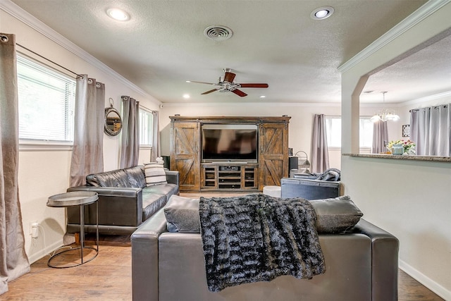 3554 Cromart Ct N, Fort Worth, TX 76133 - living room featuring baseboards, ornamental molding, ceiling fan, wood finished floors, and a chandelier