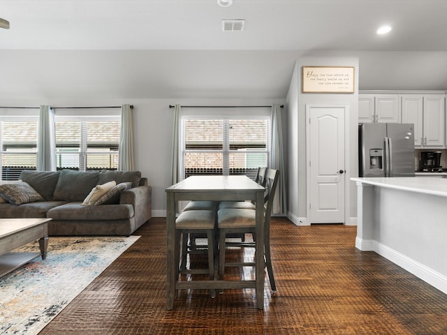 dining space featuring healthy amount of natural light, baseboards, and recessed lighting