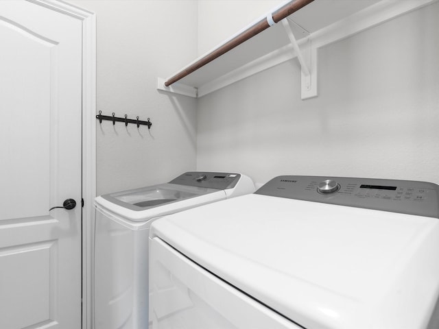 washroom featuring washer and clothes dryer