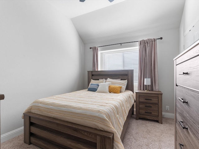 bedroom with light carpet, lofted ceiling, and baseboards