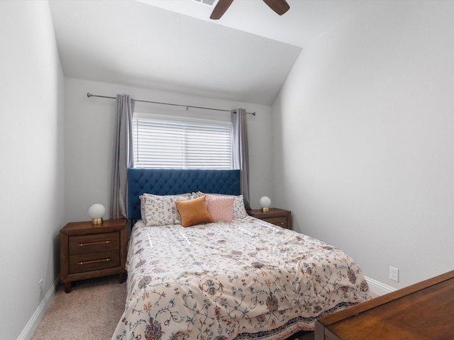carpeted bedroom with baseboards, ceiling fan, and vaulted ceiling