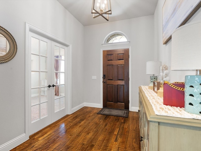 foyer featuring a chandelier, french doors, and baseboards