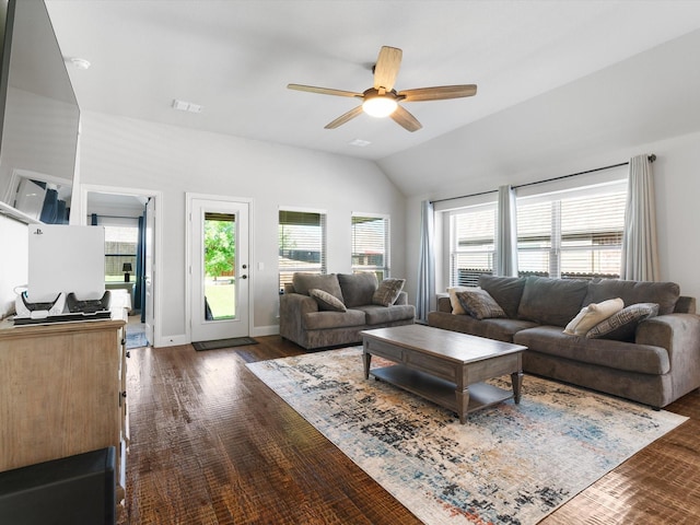 living room featuring ceiling fan, vaulted ceiling, and dark wood-type flooring