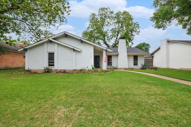 4940 Ashbrook Rd, Dallas, TX 75227 - mid-century inspired home with brick siding, a chimney, and a front yard