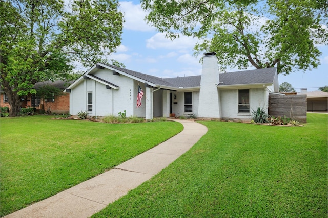 4940 Ashbrook Rd, Dallas, TX 75227 - view of front of property with roof with shingles, a front yard, a chimney, and brick siding