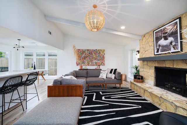 4940 Ashbrook Rd, Dallas, TX 75227 - living room featuring light wood finished floors, healthy amount of natural light, a fireplace, a chandelier, and recessed lighting