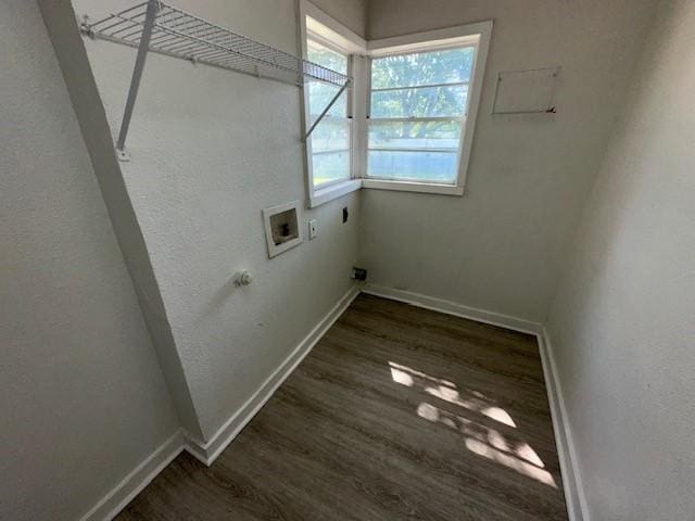 washroom featuring hookup for an electric dryer, wood finished floors, hookup for a washing machine, and baseboards