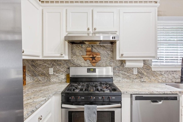 401 Mahon Hollow Dr, Waco, TX 76704 - kitchen with stainless steel appliances, wall chimney exhaust hood, white cabinetry, backsplash, and a sink