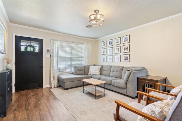 401 Mahon Hollow Dr, Waco, TX 76704 - living room with ornamental molding, wood finished floors, baseboards, and a textured ceiling