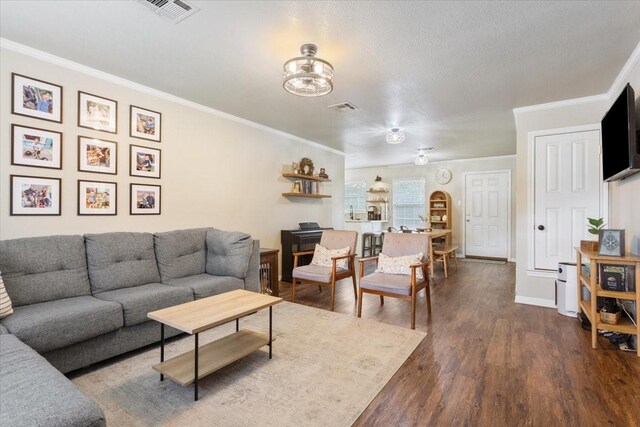 401 Mahon Hollow Dr, Waco, TX 76704 - living room featuring ornamental molding, dark wood-style flooring, a chandelier, and baseboards