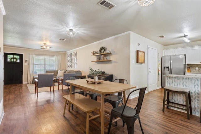401 Mahon Hollow Dr, Waco, TX 76704 - dining room featuring a textured ceiling, wood finished floors, crown molding, and baseboards
