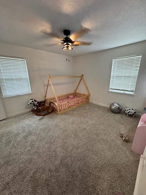 261 Barker St, Stephenville, TX 76401 - unfurnished bedroom featuring multiple windows, carpet, and ceiling fan