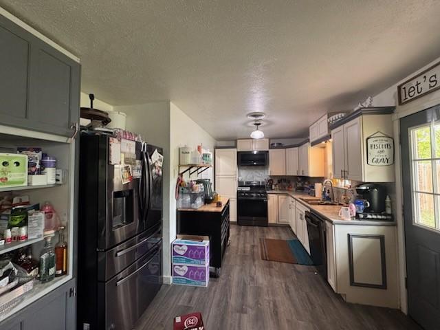 261 Barker St, Stephenville, TX 76401 - kitchen featuring fridge with ice dispenser, range with gas cooktop, dark wood-style flooring, extractor fan, and a textured ceiling