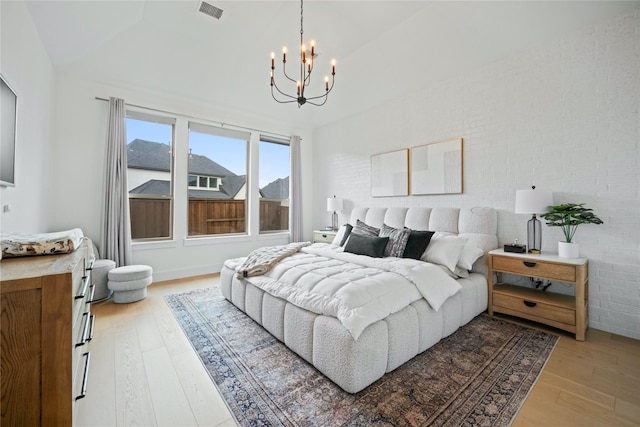 4541 Walnut Grove Ln, Prosper, TX 75078 - bedroom featuring a chandelier and light wood-style floors