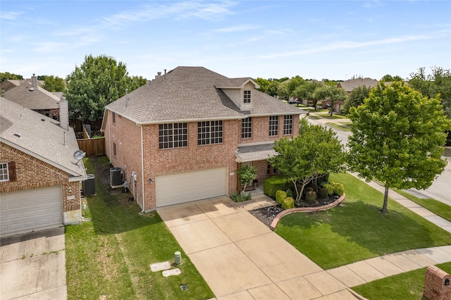 1915 Fairway Crossing Rd, Wylie, TX 75098 - view of front of property with brick siding, a shingled roof, an attached garage, and concrete driveway