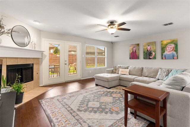 1915 Fairway Crossing Rd, Wylie, TX 75098 - living area with a ceiling fan, wood finished floors, french doors, and a fireplace