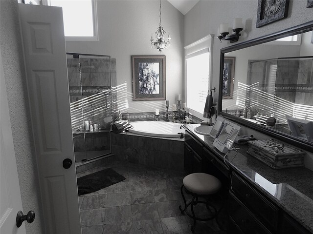 full bath featuring healthy amount of natural light, a bath, a chandelier, and vanity