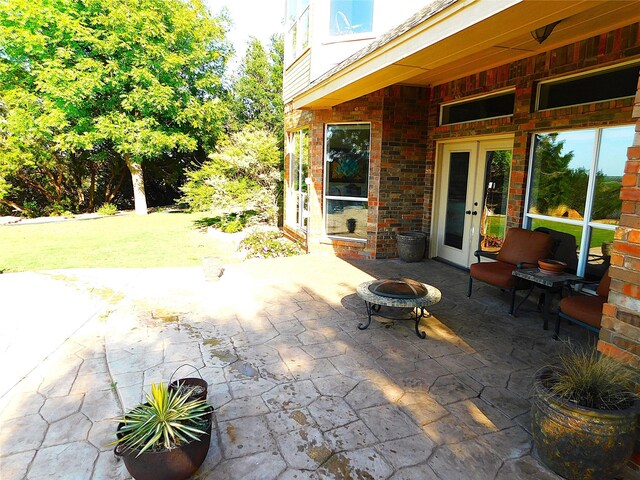 view of patio featuring french doors and an outdoor fire pit