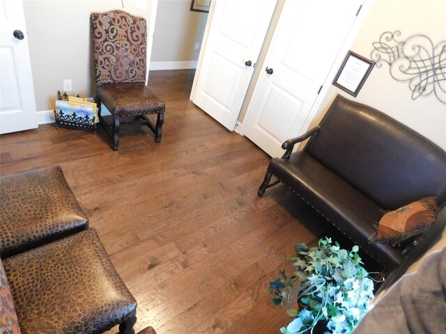 living area featuring wood finished floors and baseboards