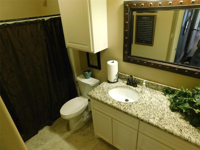 bathroom featuring toilet, tile patterned flooring, vanity, and a shower with curtain