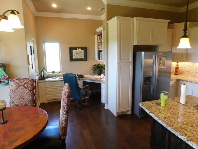 kitchen with stainless steel fridge with ice dispenser, light stone countertops, ornamental molding, dark wood finished floors, and decorative light fixtures