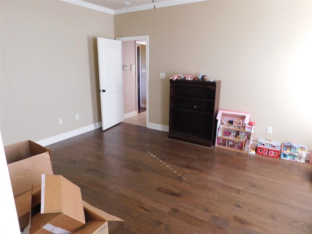 bedroom featuring ornamental molding, wood finished floors, and baseboards