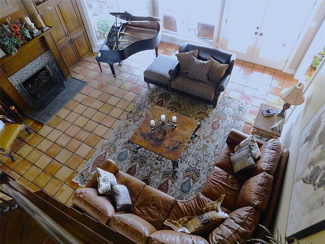 living area featuring light tile patterned flooring and a fireplace