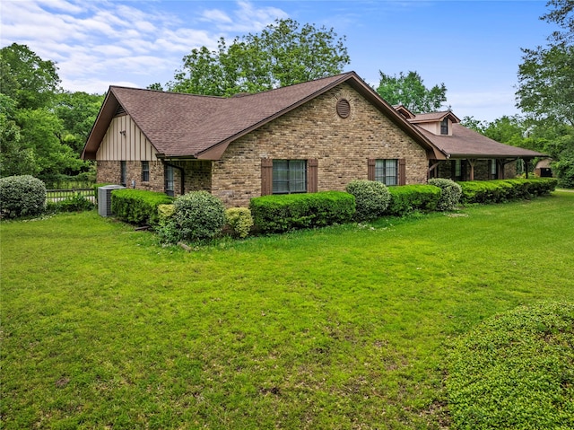 979 Rockdale, Sulphur Springs, TX 75482 - view of home's exterior with cooling unit, brick siding, board and batten siding, and roof with shingles