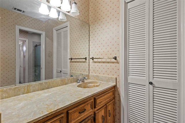 979 Rockdale, Sulphur Springs, TX 75482 - bathroom featuring wallpapered walls, a closet, and vanity